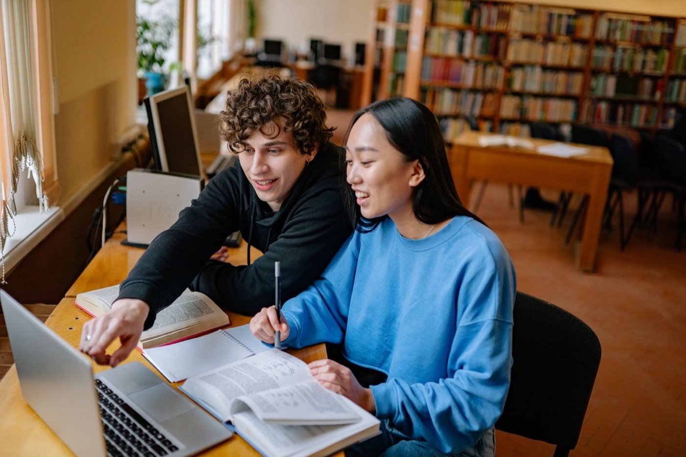 Two students studying together in a university library